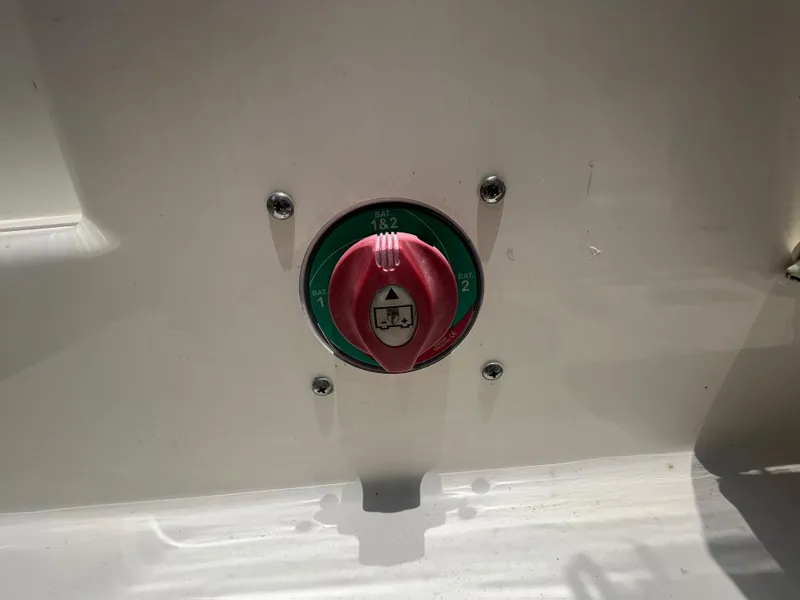 Slide: The Image of Battery switch on a 2020 Cobia 220 boat, featuring a red and green dial. - 19