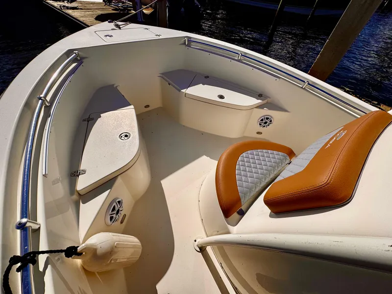 Slide: The Image of 2020 Cobia 220 boat interior with cushioned seating and storage compartments. - 2