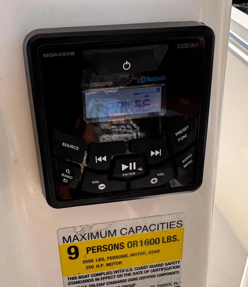 Slide: The Image of Boat stereo system on a 2020 Cobia 220, showing maximum capacity label. - 21