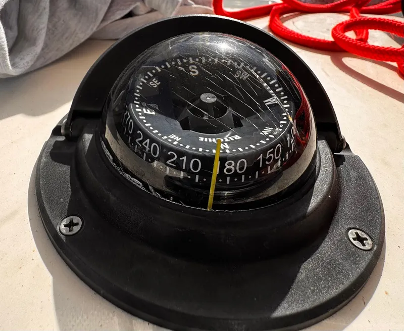Slide: The Image of Compass on a 2020 Cobia 220 boat with red rope in background. - 22