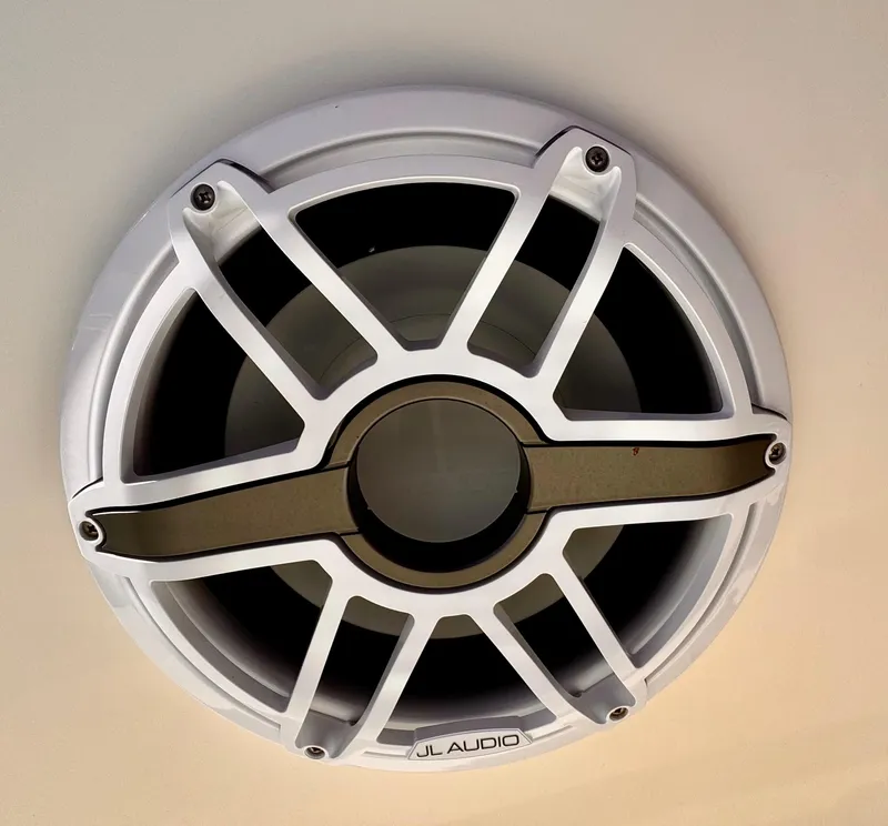 Slide: The Image of JL Audio speaker on a 2020 Cobia 220 boat, featuring a sleek white grille design. - 31