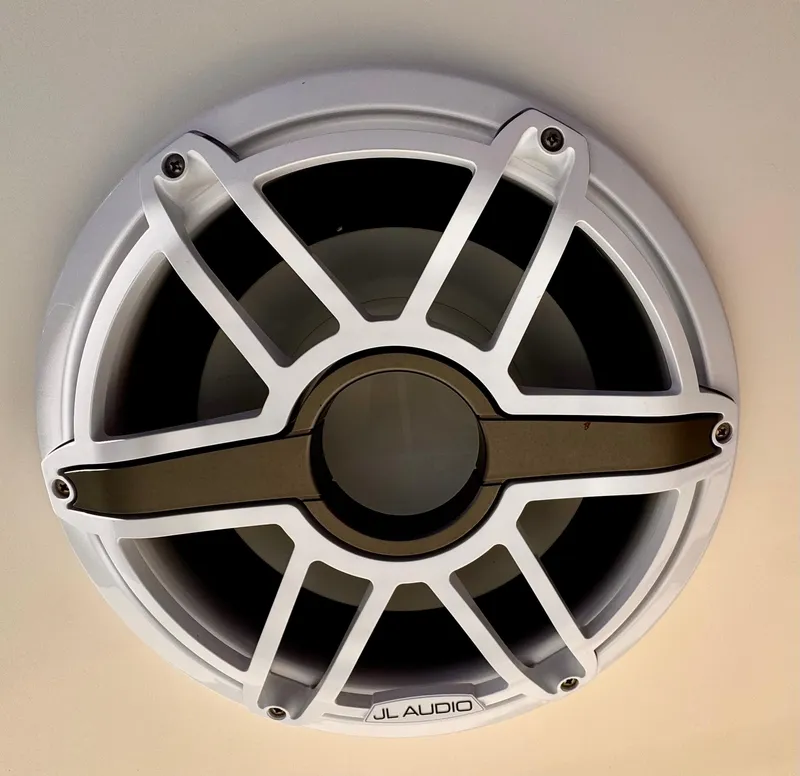 Slide: The Image of JL Audio speaker on a 2020 Cobia 220 boat, featuring a sleek white grille design. - 32