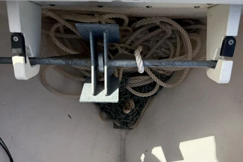 Slide: The Image of Rope storage area on a 2020 Cobia 220 boat, featuring neatly coiled ropes. - 34