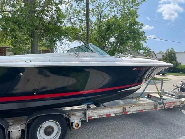 Slide: The Image of 2004 Chris-Craft Corsair 28 boat on a trailer, side view. - 11
