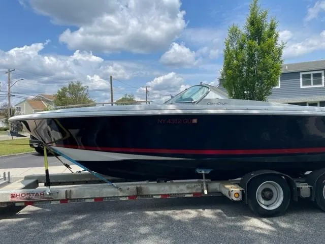 Slide: The Image of 2004 Chris-Craft Corsair 28 boat on trailer under a partly cloudy sky. - 4