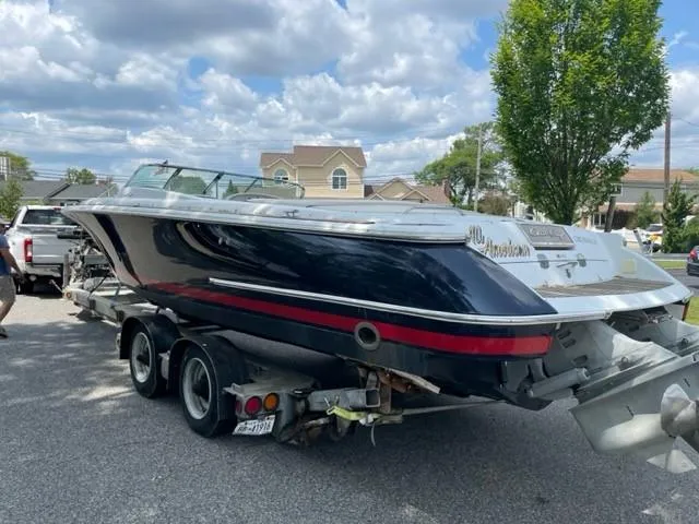 Slide: The Image of 2004 Chris-Craft Corsair 28 boat on a trailer, parked outdoors. - 6