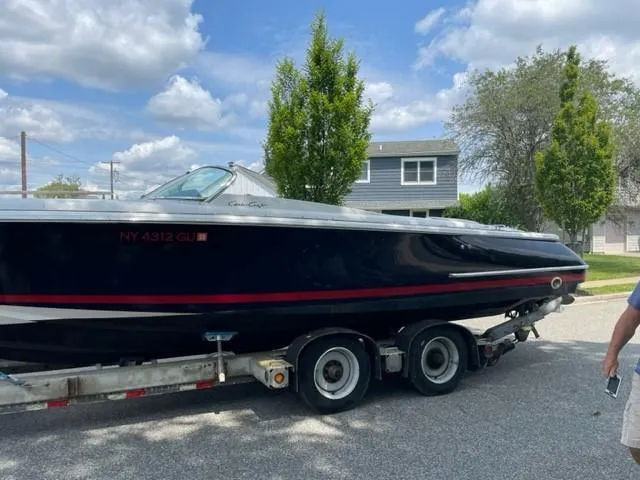 Slide: The Image of 2004 Chris-Craft Corsair 28 boat on a trailer in a suburban neighborhood. - 7