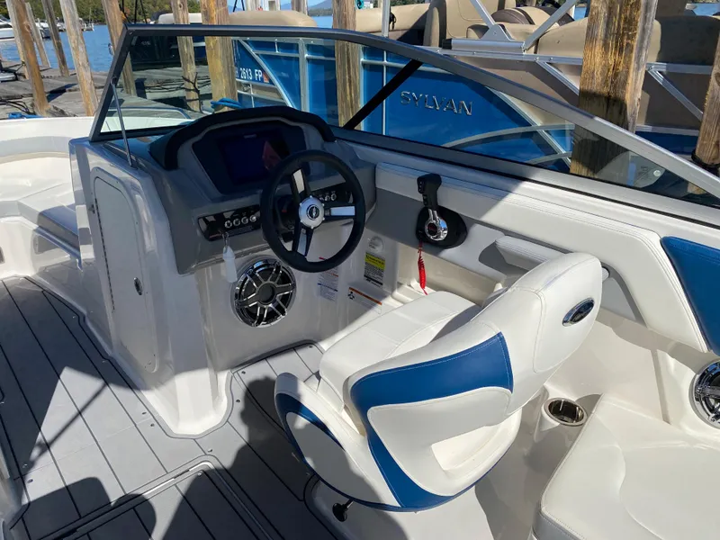 Slide: The Image of 2022 Chaparral 23 SSi boat interior with steering wheel and seating. - 10