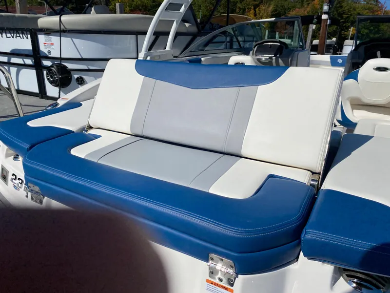 Slide: The Image of 2022 Chaparral 23 SSi boat with blue and white seating. - 13