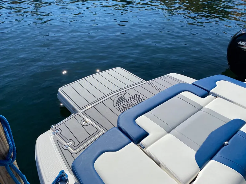 Slide: The Image of 2022 Chaparral 23 SSi boat with swim platform on calm water. - 14