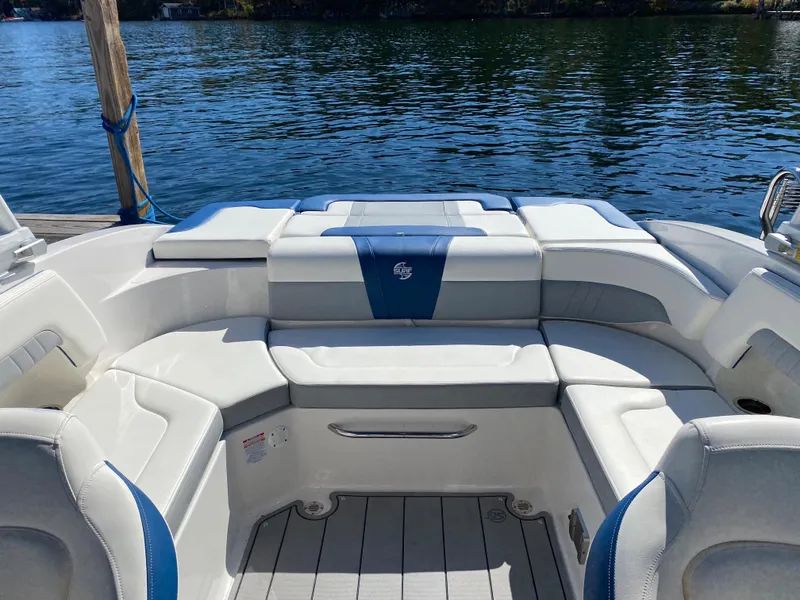 Slide: The Image of 2022 Chaparral 23 SSi boat interior with white and blue seating. - 15