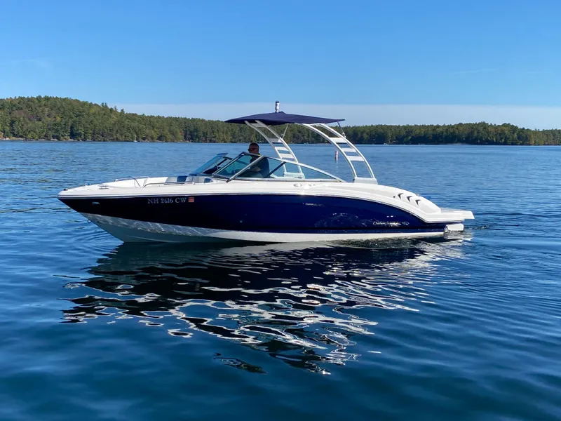 Slide: The Image of 2022 Chaparral 23 SSi boat cruising on a serene lake. - 17