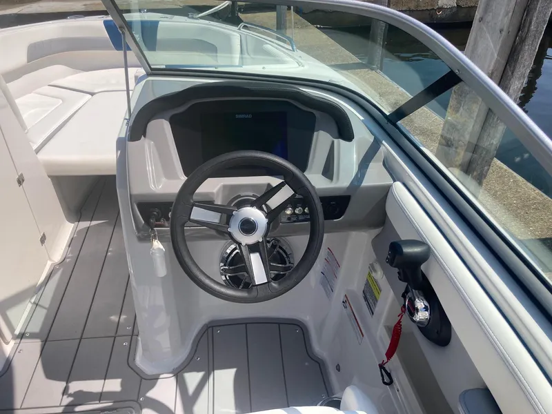 Slide: The Image of 2022 Chaparral 23 SSi boat cockpit with steering wheel and dashboard. - 2