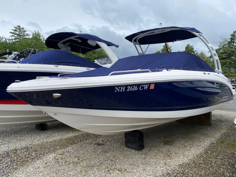 Slide: The Image of 2022 Chaparral 23 SSi boat with blue hull and covered bow on display. - 22