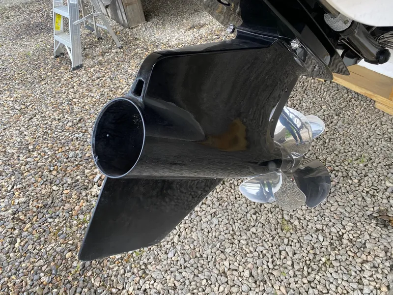 Slide: The Image of Close-up of 2022 Chaparral 23 SSi boat propeller and lower unit on gravel. - 24