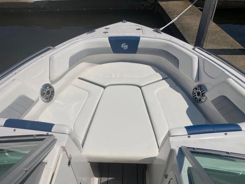 Slide: The Image of 2022 Chaparral 23 SSi boat bow seating area with white and blue upholstery. - 3