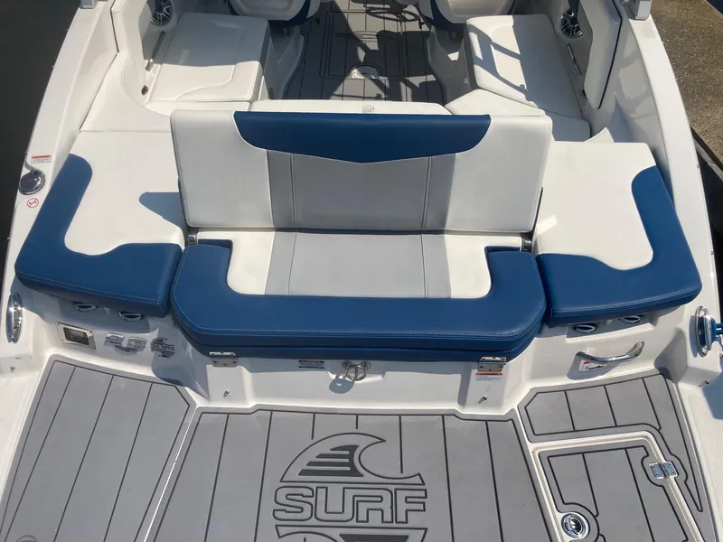 Slide: The Image of 2022 Chaparral 23 SSi boat with blue and white seating and Surf logo on deck. - 7