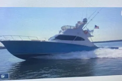 Slide: The Image of 2012 Custom Carolina Ritchie Howell 60 Sportfish cruising on water. - 2