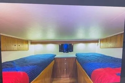 Slide: The Image of Interior cabin of 2012 Custom Carolina Ritchie Howell 60 Sportfish with twin beds and TV. - 20