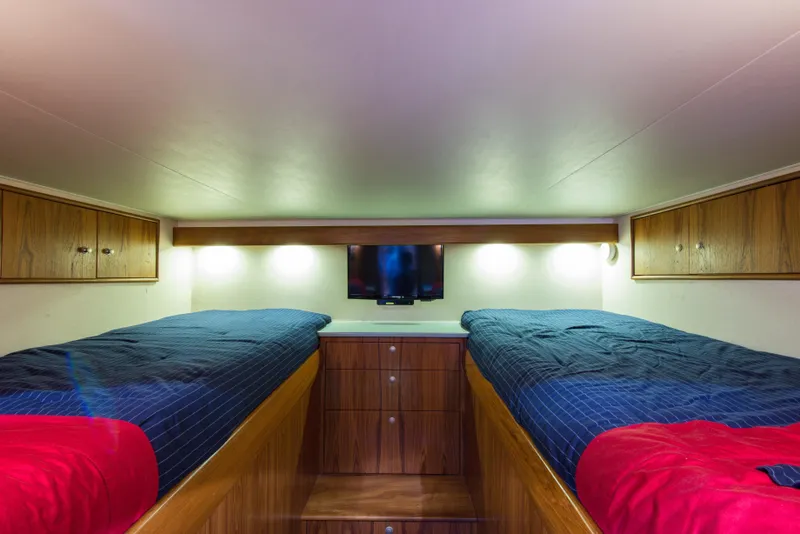 Slide: The Image of Twin beds in the cabin of a 2012 Custom Carolina Ritchie Howell 60 Sportfish yacht. - 25