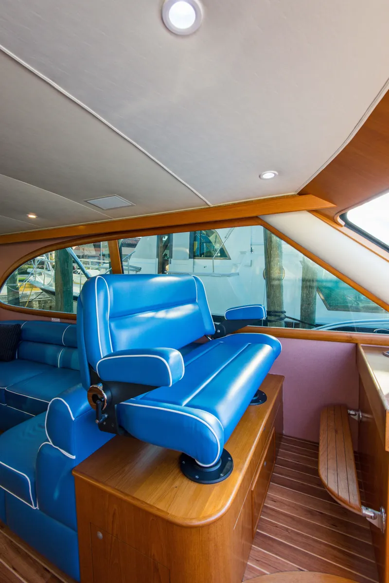 Slide: The Image of 2012 Custom Carolina Ritchie Howell 60 Sportfish interior with blue seating and wooden accents. - 27