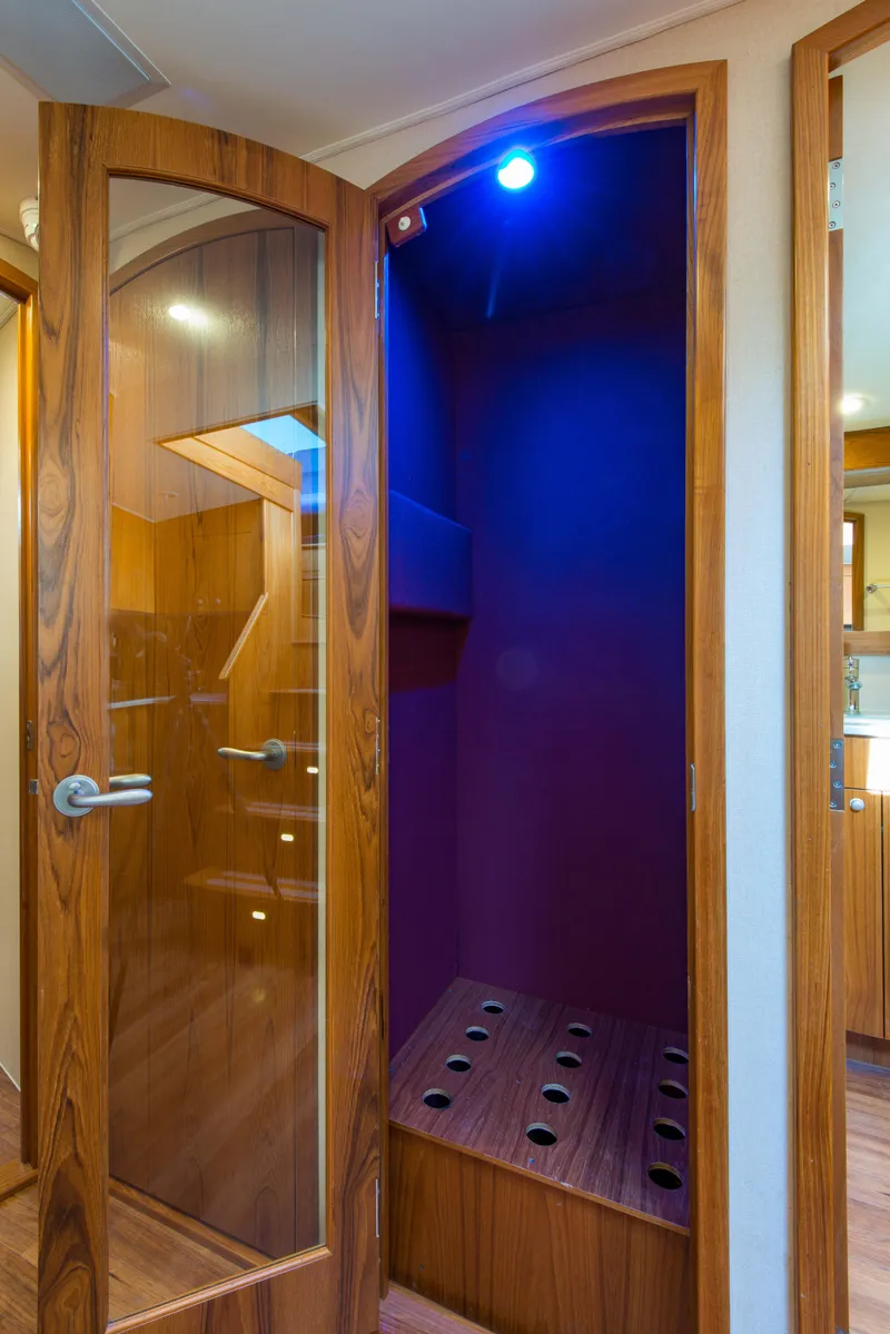 Slide: The Image of 2012 Custom Carolina Ritchie Howell 60 Sportfish interior with wooden doors and blue lighting. - 30