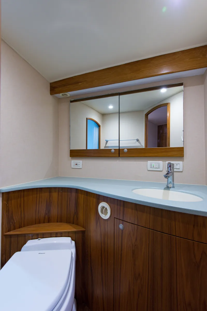 Slide: The Image of 2012 Custom Carolina Ritchie Howell 60 Sportfish bathroom with modern fixtures and wooden cabinetry. - 31