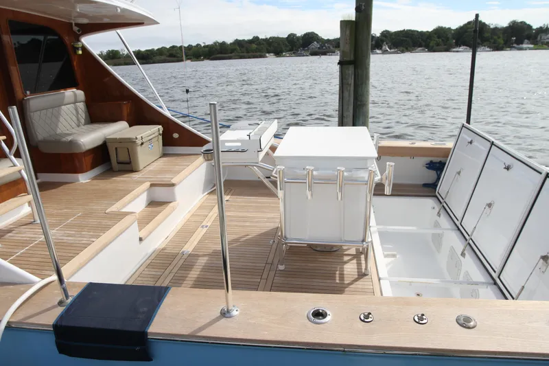 Slide: The Image of Custom Carolina Ritchie Howell 60 Sportfish 2012 boat deck with seating and fishing equipment. - 42