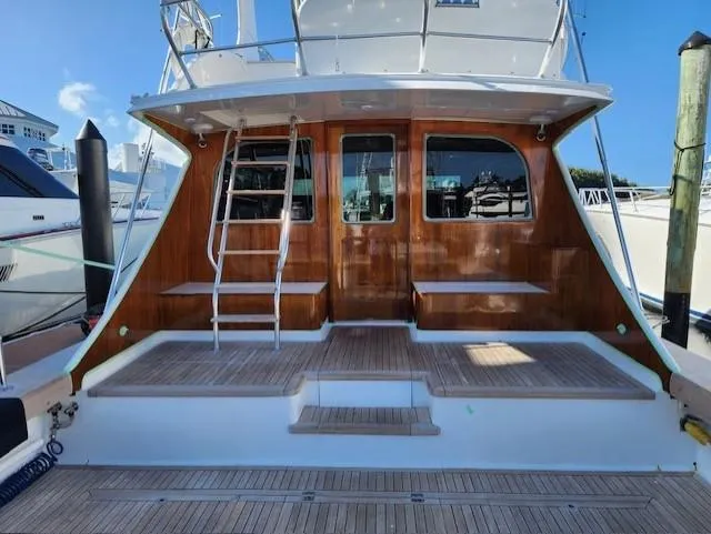 Slide: The Image of 2012 Custom Carolina Ritchie Howell 60 Sportfish yacht stern with wooden deck and ladder. - 9