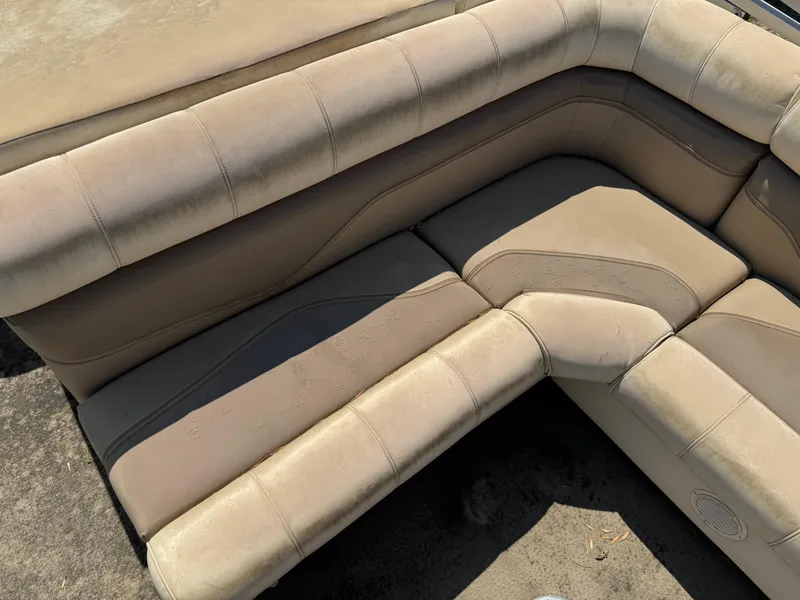 Slide: The Image of Beige seating on a 2004 Godfrey SweetWater 2019SC boat, showing corner upholstery detail. - 11