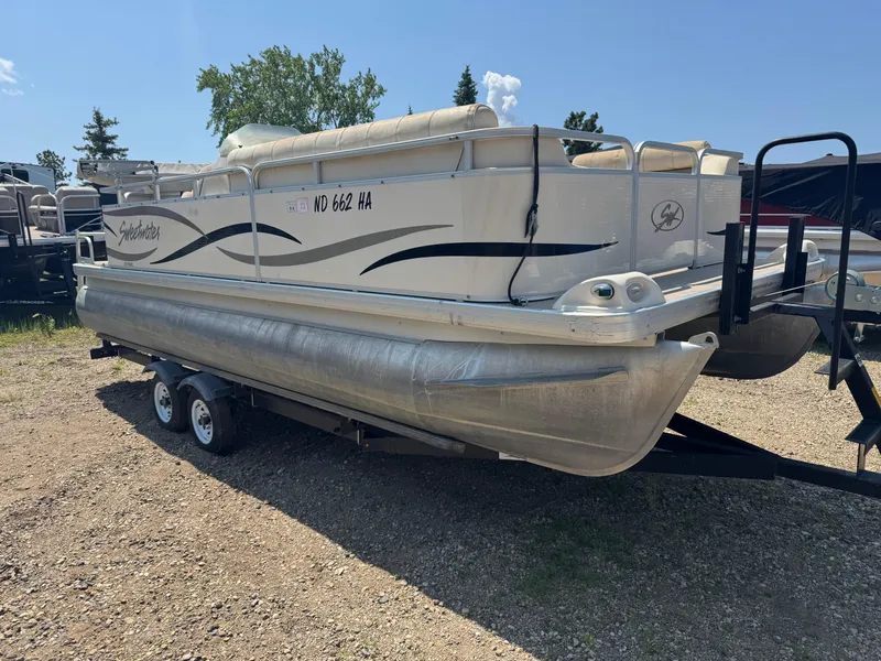 Slide: The Image of 2004 Godfrey SweetWater 2019SC pontoon boat on trailer, parked outdoors. - 2