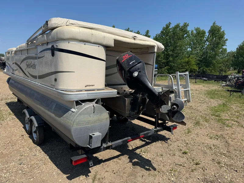 Slide: The Image of 2004 Godfrey SweetWater 2019SC pontoon boat with outboard motor on trailer. - 4
