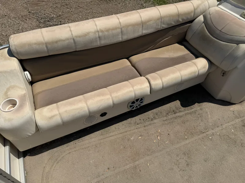 Slide: The Image of Beige seating on a 2004 Godfrey SweetWater 2019SC boat, showing wear and outdoor exposure. - 5