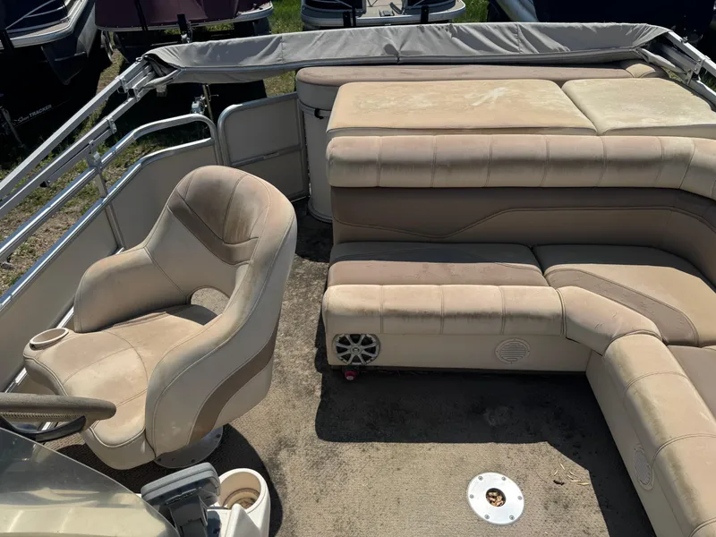 Slide: The Image of Interior of a 2004 Godfrey SweetWater 2019SC pontoon boat with beige seating. - 8