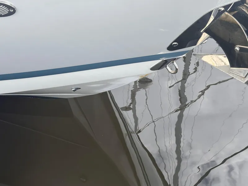 Slide: The Image of Close-up of 2022 Cobalt 30SC boat hull reflecting on water. - 10
