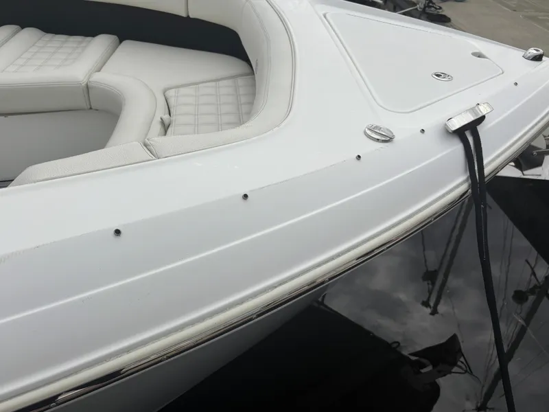 Slide: The Image of 2022 Cobalt 30SC boat with sleek white exterior and cushioned seating. - 11