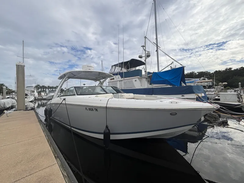 Slide: The Image of 2022 Cobalt 30SC boat docked at marina under cloudy sky. - 13