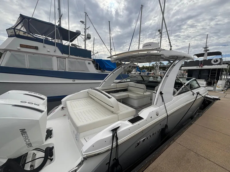 Slide: The Image of 2022 Cobalt 30SC boat docked, featuring spacious seating and Mercury engine. - 15