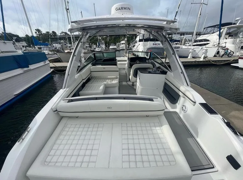 Slide: The Image of 2022 Cobalt 30SC boat interior at marina, featuring white seating and Garmin navigation. - 17