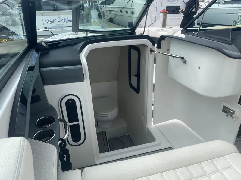 Slide: The Image of 2022 Cobalt 30SC boat interior with compact bathroom and modern design. - 24