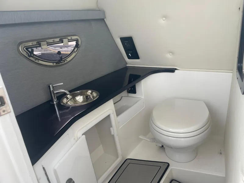 Slide: The Image of 2022 Cobalt 30SC boat bathroom with sink and toilet, modern design. - 28