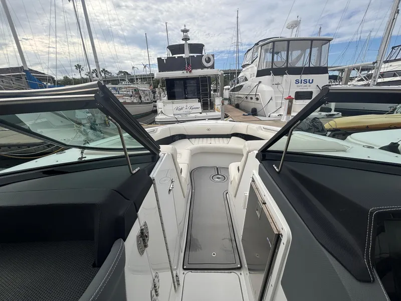 Slide: The Image of 2022 Cobalt 30SC boat interior at marina, surrounded by other boats. - 29