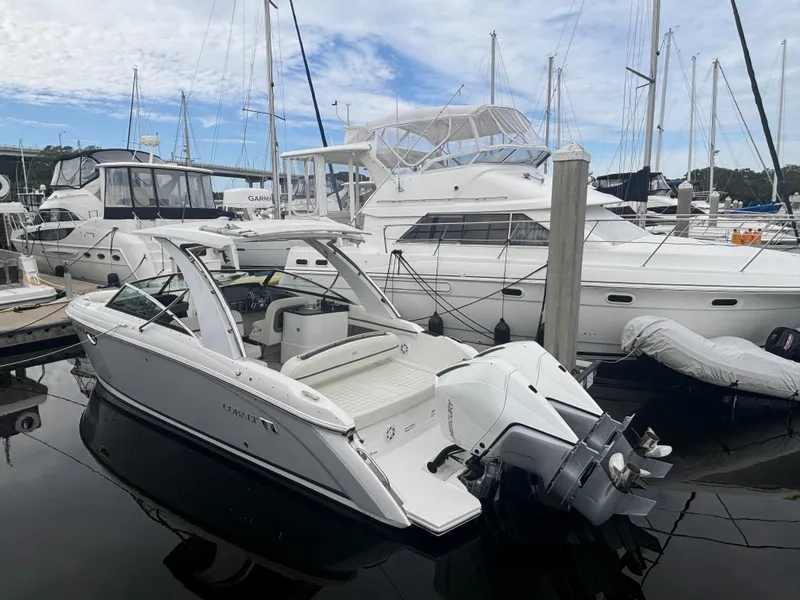 Slide: The Image of 2022 Cobalt 30SC boat docked at marina with other yachts. - 3