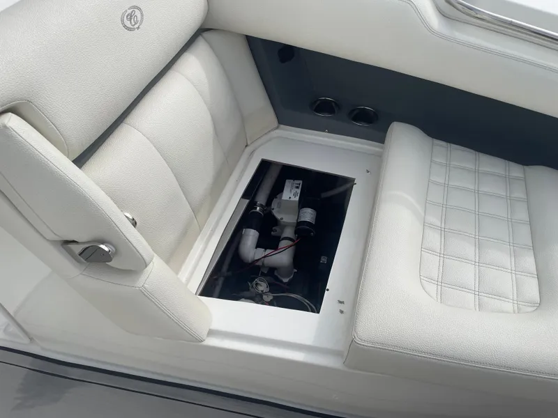 Slide: The Image of Cobalt 30SC 2022 boat interior with open storage compartment and white seating. - 31