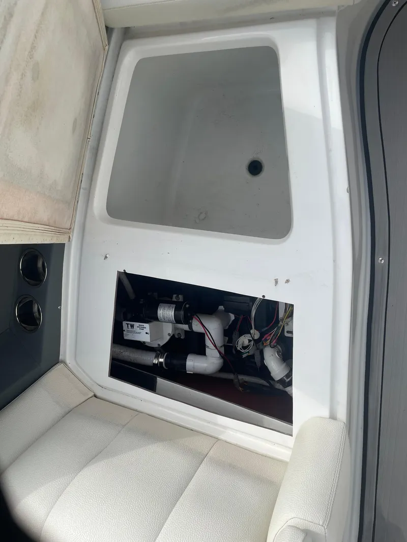 Slide: The Image of Interior view of a 2022 Cobalt 30SC boat showing storage compartment and seating. - 32