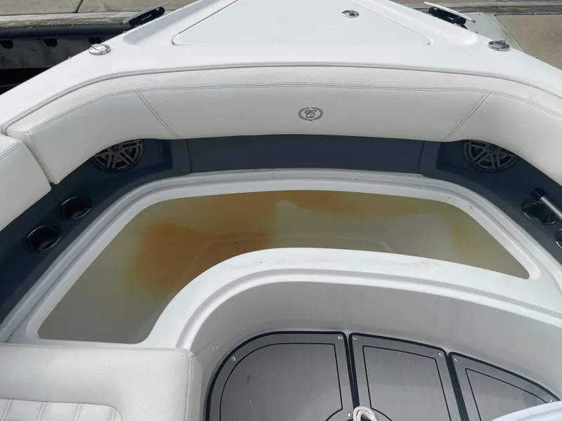 Slide: The Image of 2022 Cobalt 30SC boat interior with cushioned seating and storage area. - 34