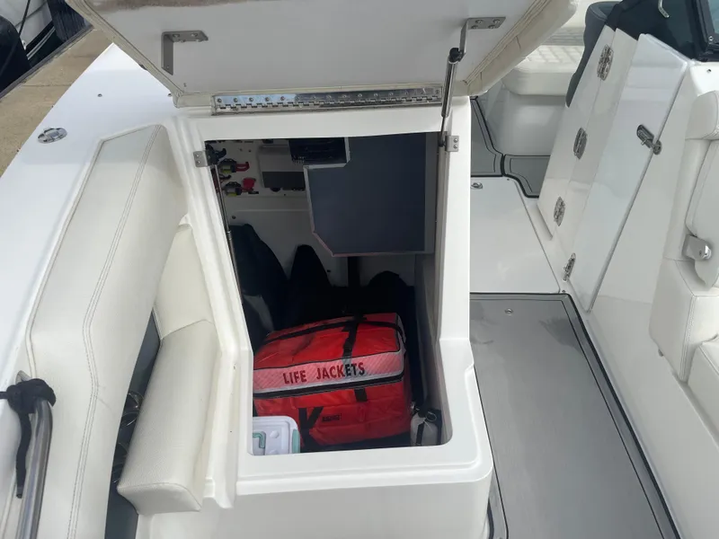 Slide: The Image of 2022 Cobalt 30SC boat storage compartment with life jackets. - 38