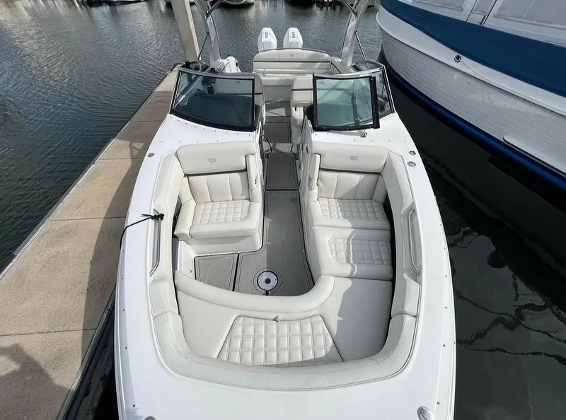 Slide: The Image of 2022 Cobalt 30SC boat with luxurious white seating docked at marina. - 41