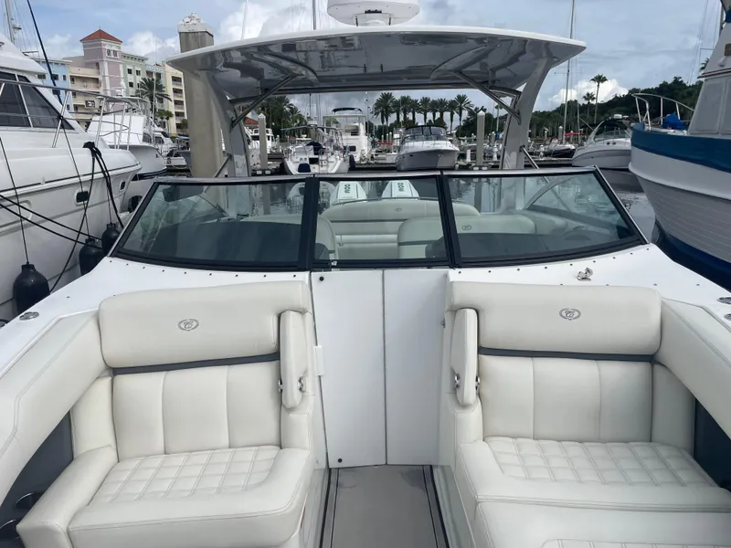 Slide: The Image of 2022 Cobalt 30SC boat with white seating at a marina. - 42