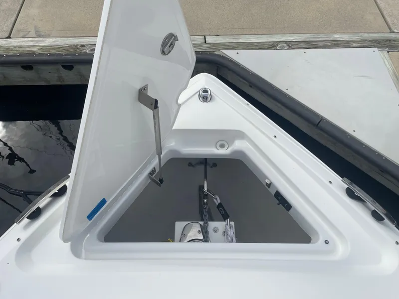 Slide: The Image of Open anchor compartment on 2022 Cobalt 30SC boat at dock. - 49
